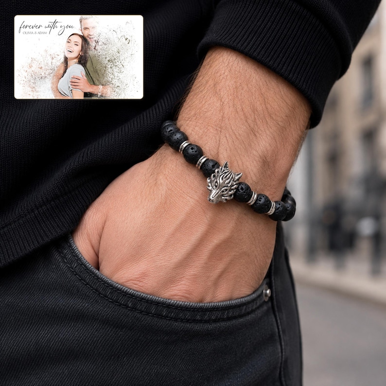 Black bead bracelet with silver-tone wolf-head detail, adult lifestyle view. A personalized greeting-card example appears in the corner.