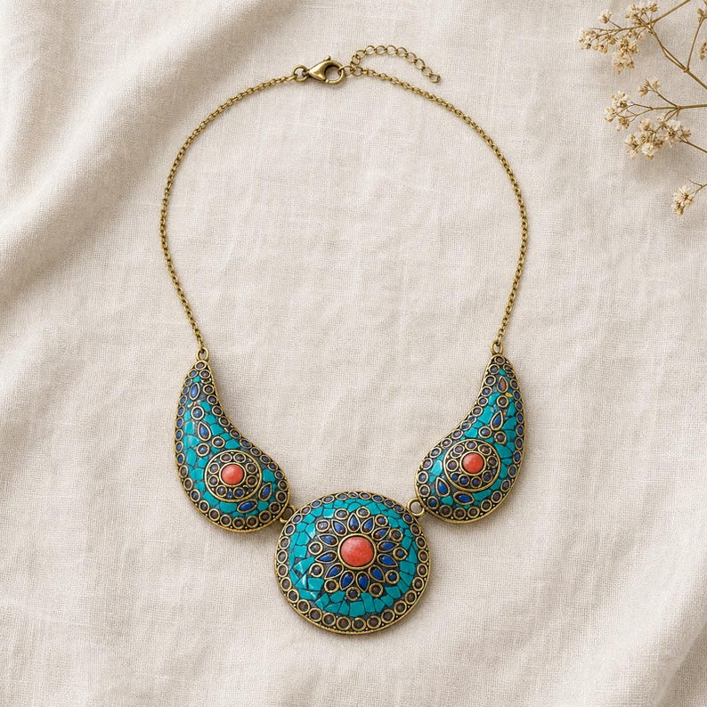 Gift ready presentation of Turquoise and coral three medallion statement necklace with antique gold chain in an open jewelry box lined with natural ivory linen