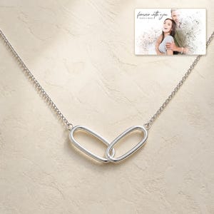 Everlinked Sterling Necklace photographed in warm natural window light in an elegant home setting.