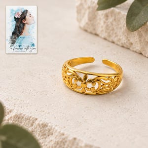 Golden Bloom Filigree Ring shown on a clean white catalog background for an unobstructed product view. A personalized digital greeting card is shown alongside.