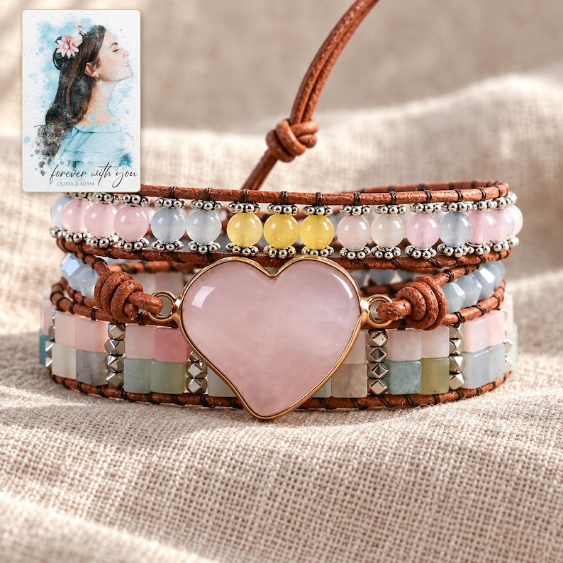 Pastel Heart Wrap Bracelet arranged on soft ivory linen in a refined neutral flat lay. A personalized digital greeting card is shown alongside.