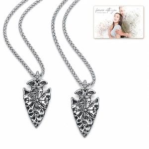 Aegis North Nordic Arrowhead Necklace shown during a believable gift-giving moment between adults with the exact jewelry visible.