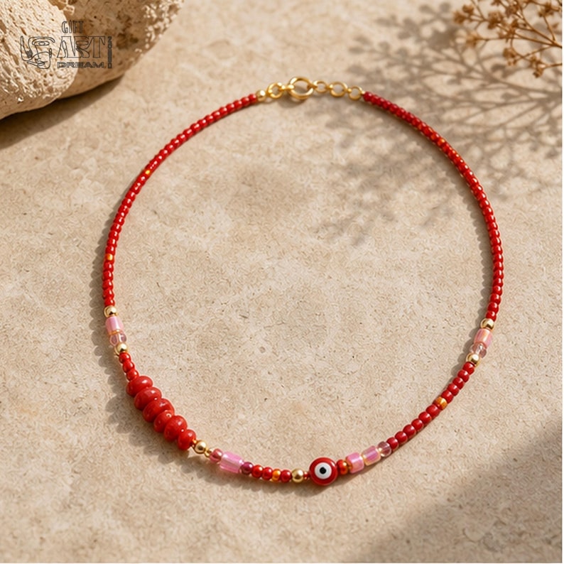 Three-piece handmade necklace set featuring turquoise beaded fish evil eye beaded necklace, red evil eye beaded necklace and red evil eye beaded necklace, displayed together to show the coordinated colors and beadwork