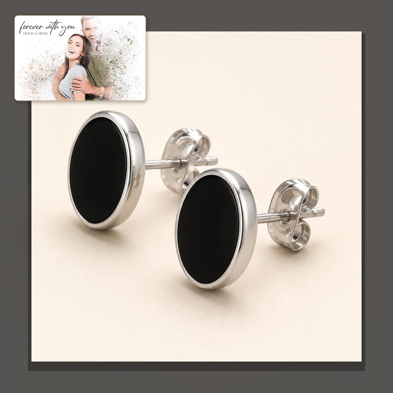 Black oval stud earrings with silver-tone edges, dark-bordered product view. A personalized greeting-card example appears in the corner.