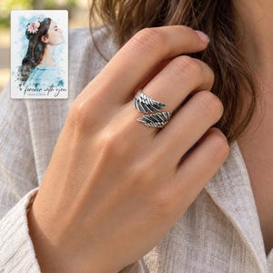 Angel Wings Wrap Ring, worn by an adult. A sample personalized digital greeting card is shown alongside.