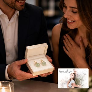 Celadon Jade Look Ear Clips shown during a believable gift-giving moment between adults with the exact jewelry visible.