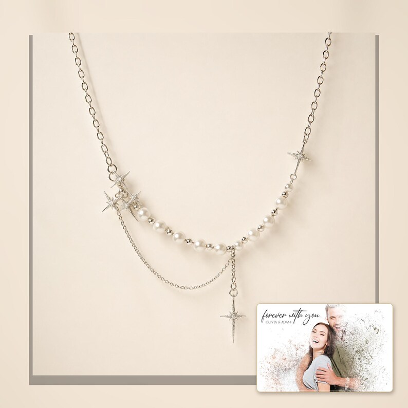 Silver-tone layered necklace with pale beads and pointed star charms, framed product view. A personalized greeting-card example appears in the corner.
