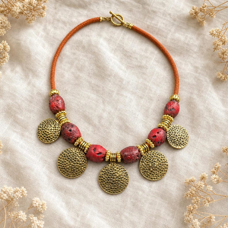 Red Beaded Coin Charm Necklace presented in an open jewelry gift box on natural linen