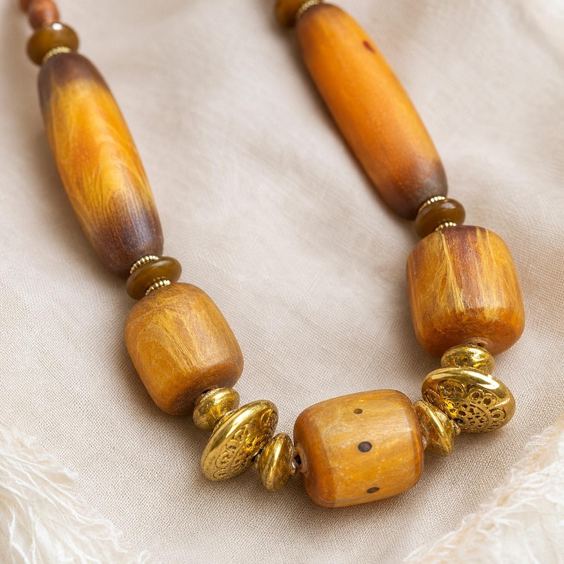 Three-piece handmade necklace set featuring brown and gold beaded necklace, rose gold and beige beaded necklace and rose gold and beige beaded necklace, displayed together to show the coordinated colors and beadwork