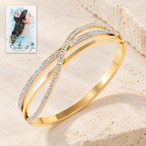 Crossover Bangle Bracelet, shown on a display surface. A sample personalized digital greeting card is shown alongside.