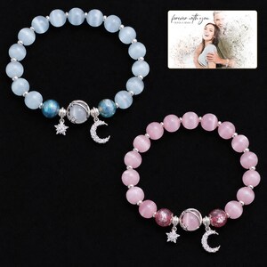 Starlit Moon Bead Bracelet shown during a warm gift-receiving moment between adults with the exact jewelry visible.