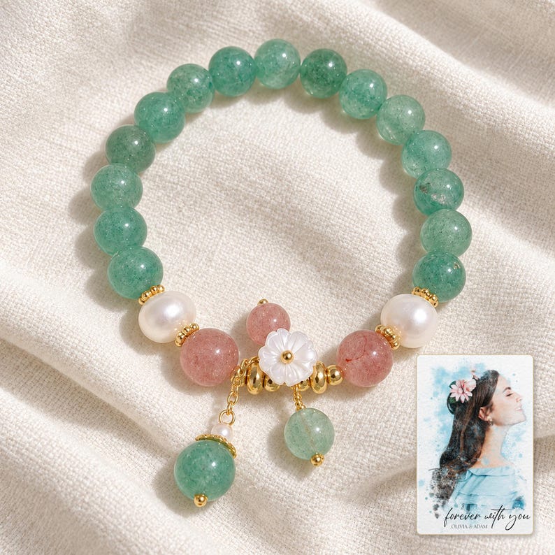Forest Strawberry clear accents Bracelet arranged on soft ivory linen in a refined neutral flat lay. A personalized digital greeting card is shown alongside.