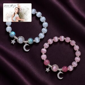 Starlit Moon Bead Bracelet arranged on soft ivory linen in a refined neutral flat lay.