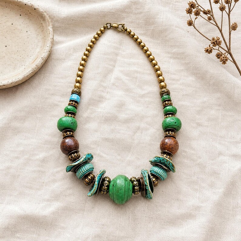 Rose Gold and Gray Statement Beaded Necklace presented in an open jewelry gift box on natural linen