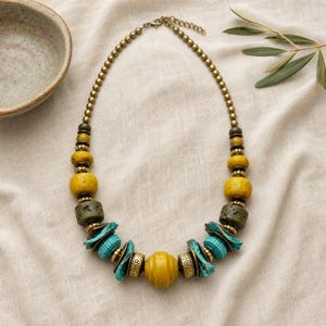 Rose Gold and Gray Statement Beaded Necklace presented in an open jewelry gift box on natural linen