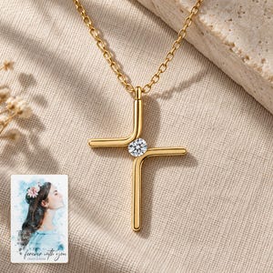 Cross Pendant Necklace, laid on fabric. A sample personalized digital greeting card is shown alongside.