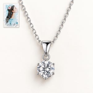 Moissanite Pendant Necklace, shown against a light background. A sample personalized digital greeting card is shown alongside.