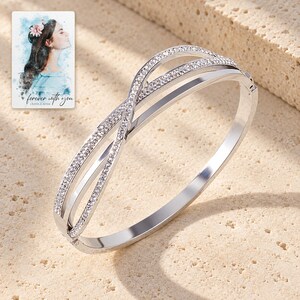 Crossover Bangle Bracelet, shown in natural light. A sample personalized digital greeting card is shown alongside.