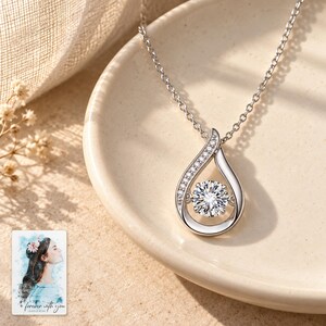 Moissanite Teardrop Necklace, shown in natural light. A sample personalized digital greeting card is shown alongside.