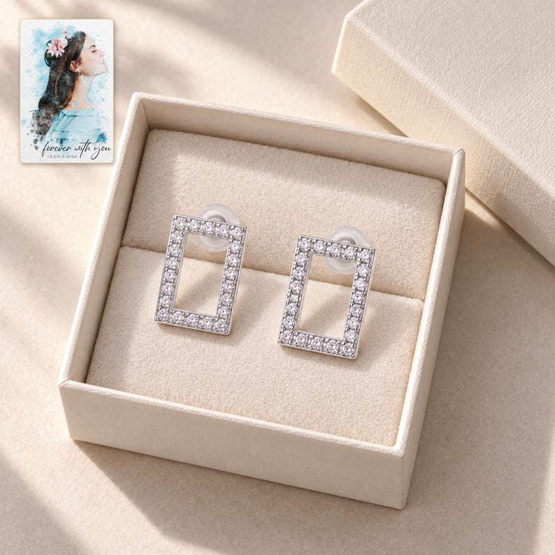 Rectangle Moissanite Stud Earrings, displayed in a presentation box. A sample personalized digital greeting card is shown alongside.