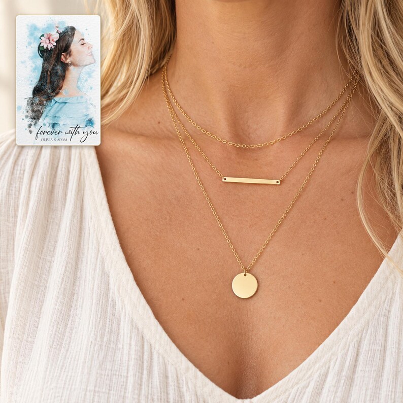 Adult woman wearing the plain chain, narrow bar necklace and smooth disc necklace with an ivory blouse. A personalized digital greeting card is shown alongside.