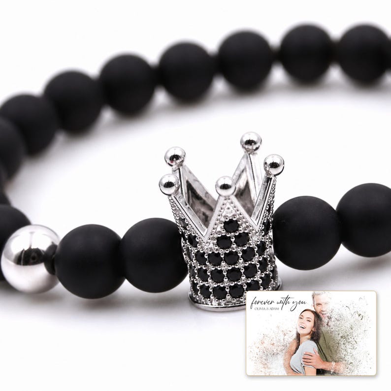 Midnight Crown Bead Bracelet shown during a warm gift-receiving moment between adults with the exact jewelry visible.