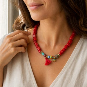 Red and Brown Statement Beaded Necklace displayed on a jewelry bust with the layered beadwork and pendants visible