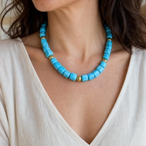 Gray and Silver Statement Beaded Necklace presented in an open jewelry gift box on natural linen