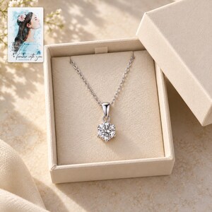 Moissanite Pendant Necklace, displayed in a presentation box. A sample personalized digital greeting card is shown alongside.