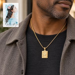 Adult man wearing a gold tone M initial necklace with charcoal evening clothing. A personalized digital greeting card is shown alongside.