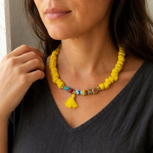 Yellow and Gold Statement Beaded Necklace worn with an ivory linen top in warm natural window light