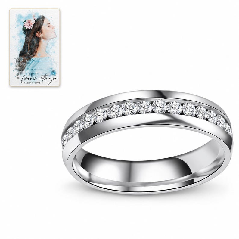 Single silver-tone clear accents band photographed on white, showing its continuous round shape and plain reflective interior. A personalized digital greeting card is shown alongside.
