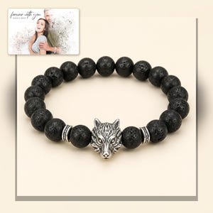 Black bead bracelet with silver-tone wolf-head detail, framed product view. A personalized greeting-card example appears in the corner.