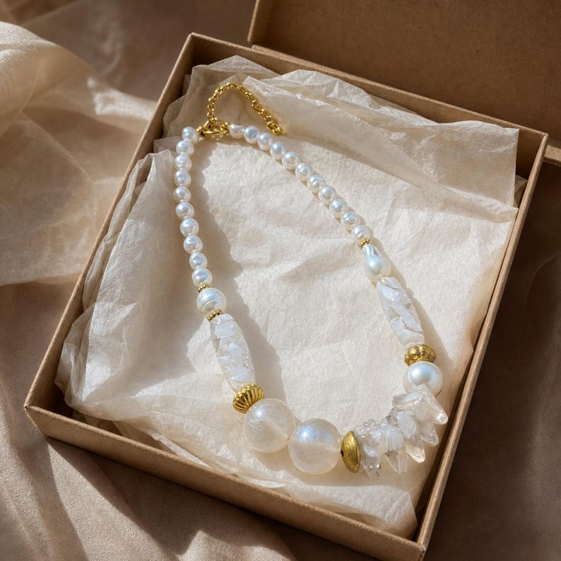 Three-piece handmade necklace set featuring beige and silver beaded necklace, silver and beige beaded necklace and silver and gray beaded necklace, displayed together to show the coordinated colors and beadwork