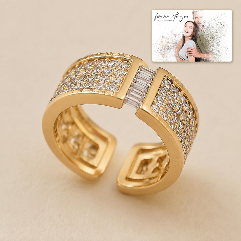 Gold-tone open ring with rows of clear accents, display view. A personalized greeting-card example appears in the corner.