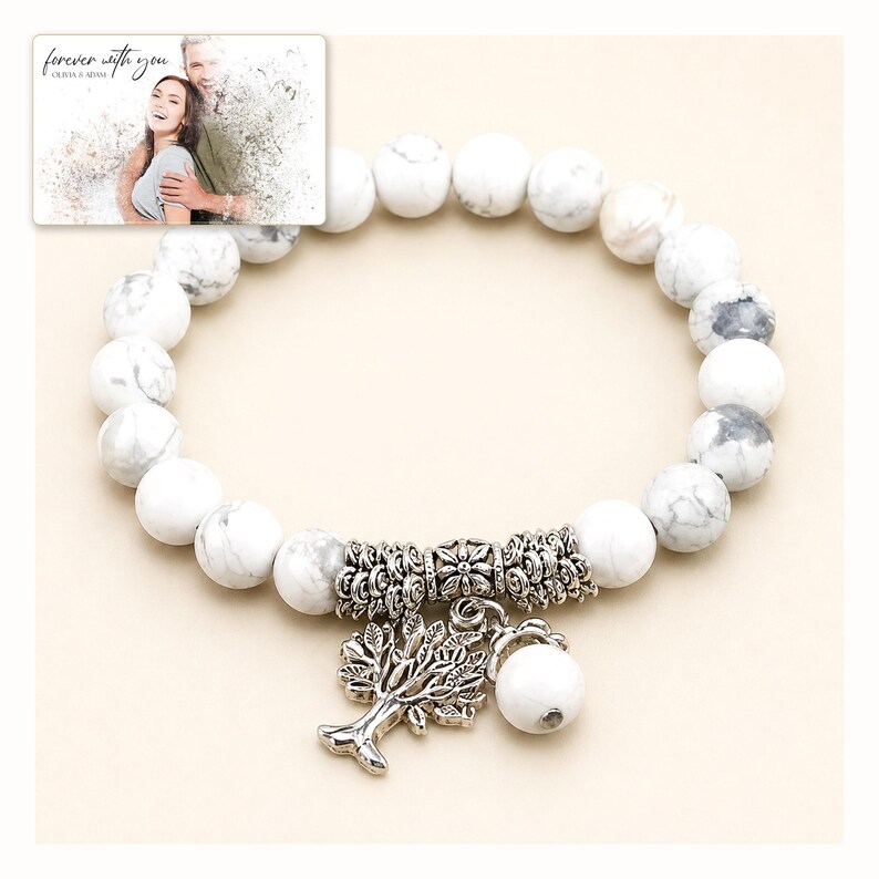 White and gray bead bracelet with silver-tone tree and hanging bead details, catalog view. A personalized greeting-card example appears in the corner.