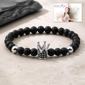 Midnight Crown Bead Bracelet photographed in warm natural window light in an elegant home setting.
