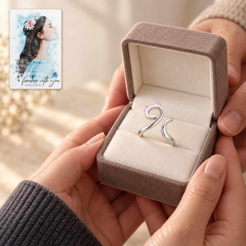 An adult receives a small open jewelry styling box with the pink-ear cat-curl ring visible. A personalized digital greeting card is shown alongside.