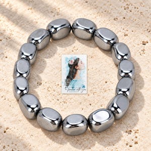 Metallic Grey Bead Bracelet, sunlit home view. A personalized digital greeting card is shown alongside.