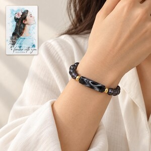 Midnight Marble Bar Bracelet worn by an adult model for styling and everyday styling. A personalized digital greeting card is shown alongside.