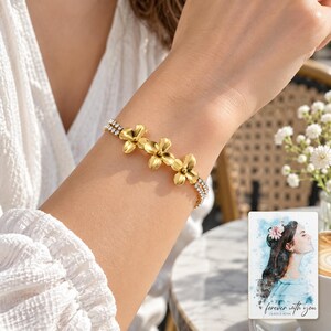 Gold Tone Flower Bracelet, human lifestyle view. A personalized digital greeting card is shown alongside.