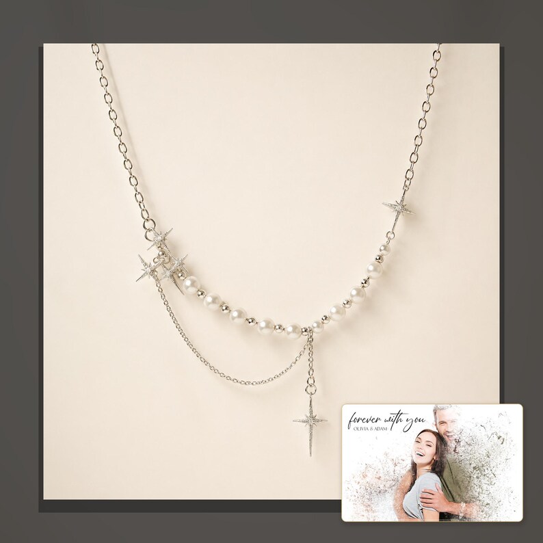 Silver-tone layered necklace with pale beads and pointed star charms, dark-bordered product view. A personalized greeting-card example appears in the corner.