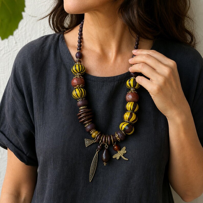 Three-piece handmade necklace set featuring brown and yellow beaded necklace, brown and bronze beaded necklace and gray and brown beaded necklace, displayed together to show the coordinated colors and beadwork