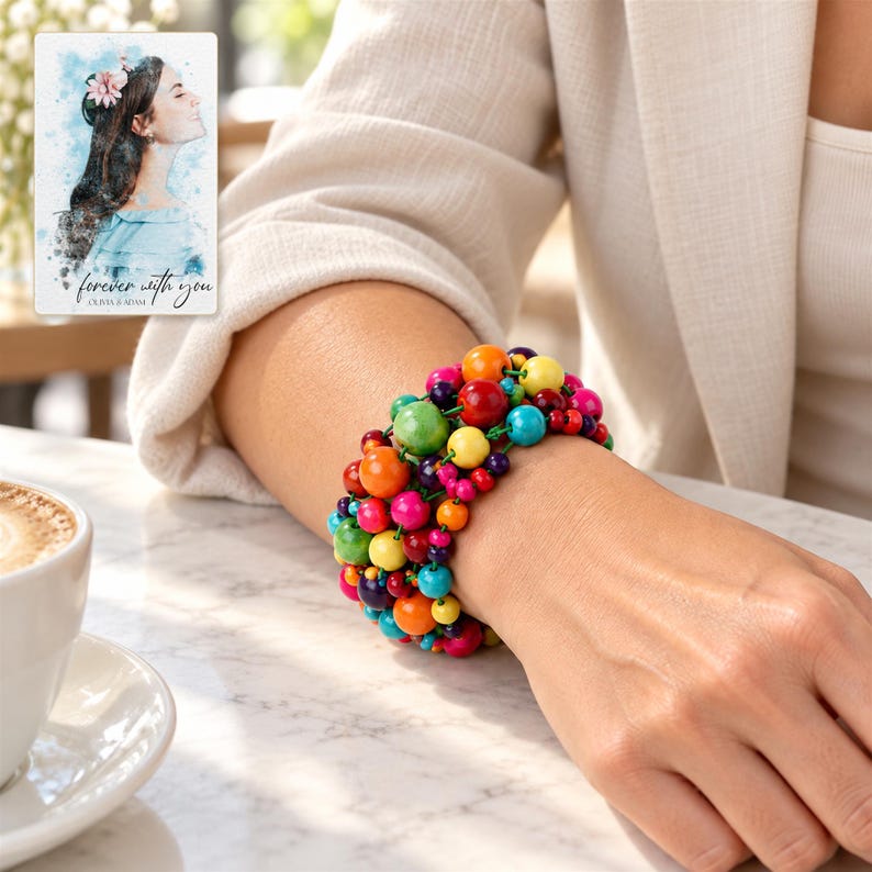 Rainbow Bead Bracelet worn by an adult in a natural daytime lifestyle scene. A personalized digital greeting card is shown alongside.
