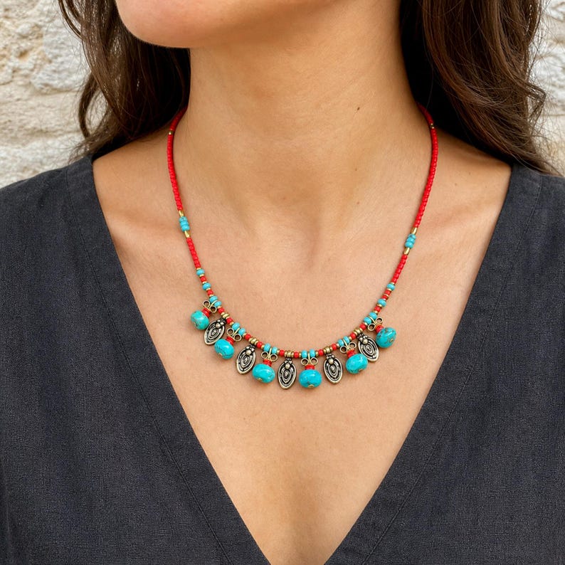 Three-piece handmade necklace set featuring turquoise red beaded charm beaded necklace, turquoise beaded starfish charm beaded necklace and red beaded coin charm beaded necklace, displayed together to show the coordinated colors and beadwork