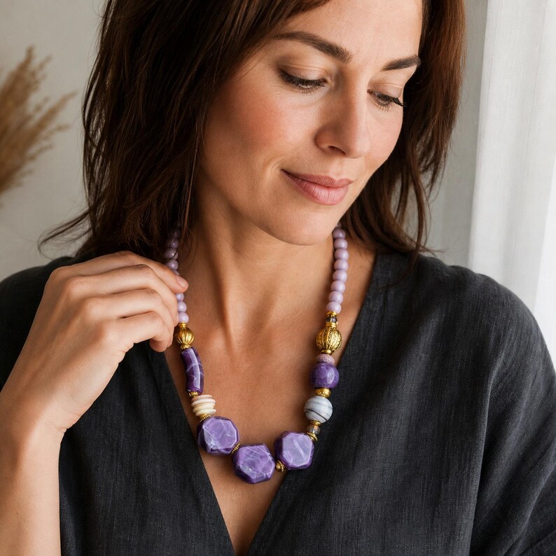 Three-piece handmade necklace set featuring purple and lavender beaded necklace, blue and silver beaded necklace and silver and brown beaded necklace, displayed together to show the coordinated colors and beadwork