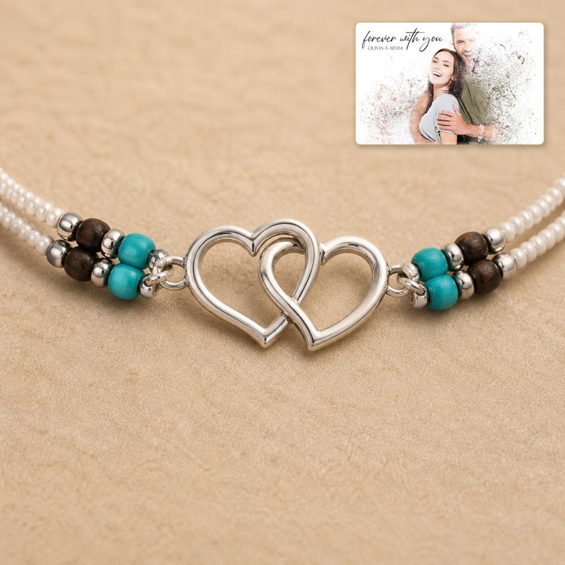 Tidal Hearts Beaded Anklet shown during a warm gift-receiving moment between adults with the exact jewelry visible.