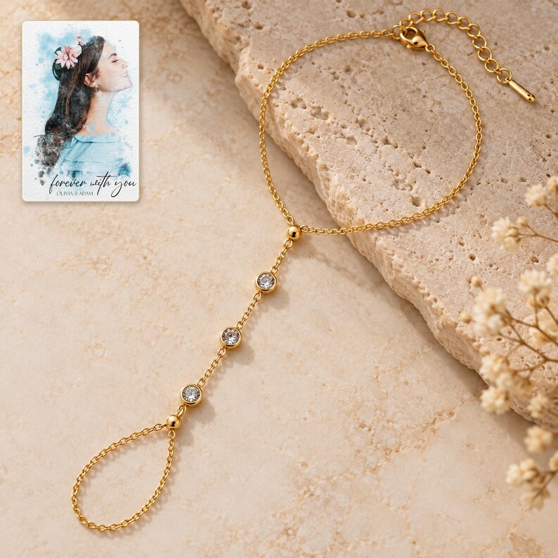 Golden Three stone style Hand Chain shown in a close macro view highlighting the visible texture, texture and construction details. A personalized digital greeting card is shown alongside.
