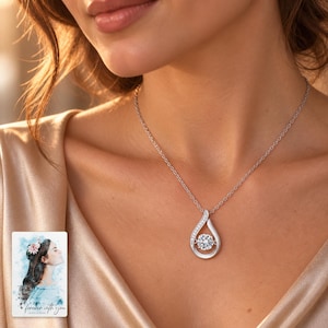 Moissanite Teardrop Necklace, worn with evening clothing. A sample personalized digital greeting card is shown alongside.