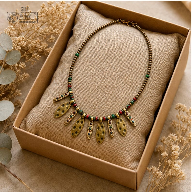 Antique Gold Leaf Charm Necklace presented in an open jewelry gift box on natural linen